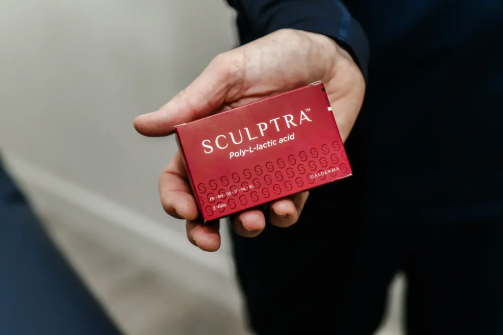 Hand holding a Scultra red box
