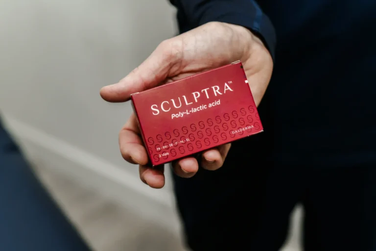 Hand holding a Scultra red box
