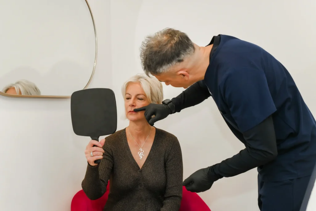 Stuart analysing a woman's lip before a thin lip treatment