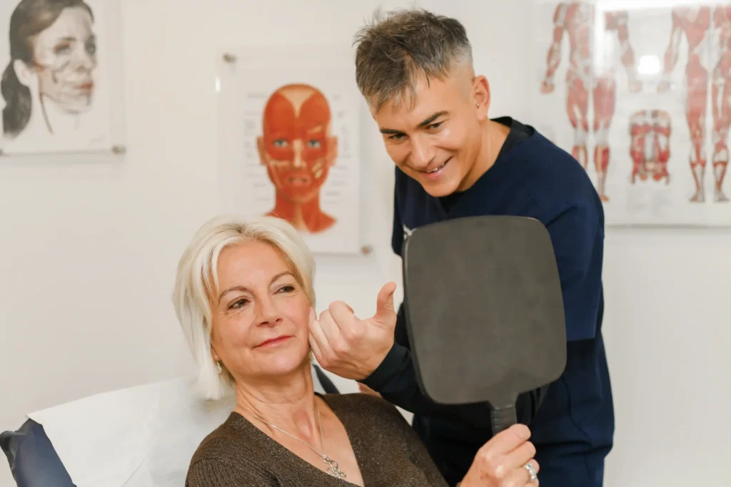 Woman holding a mirror following a treatment